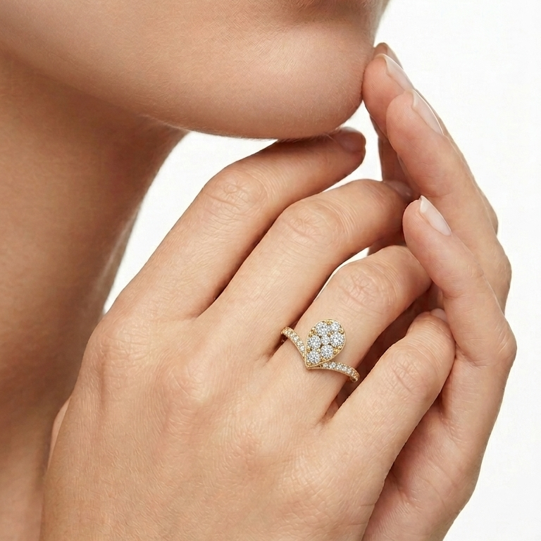 Round lab-grown diamond cluster pave chevron ring on a woman's finger.